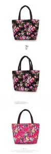 Close-up of floral canvas tote bags showing rose and daisy prints with brown handles