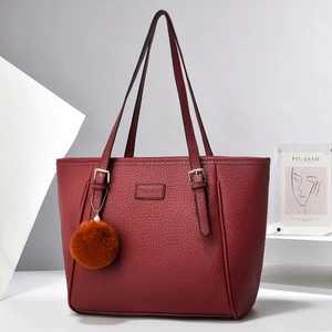 Dunkelrote Tragetasche aus strukturiertem Leder für Damen auf minimalistischem Podest