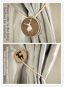 Detail of wooden deer curtain tiebacks showing different tying methods on grey drapes