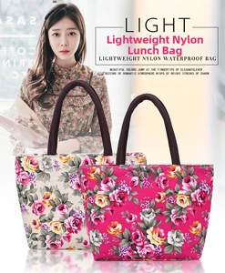 Floral nylon lunch bag with woven handles in beige and deep pink floral patterns