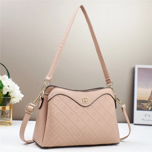 Detail showing clover embossed faux leather and pale gold hardware on pink crossbody bag