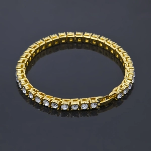 Close-up of gold hip hop tennis bracelet with rows of sparkling white zircons