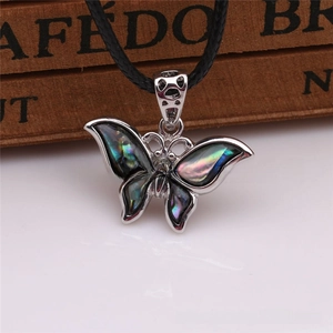 Close-up of butterfly pendant with iridescent abalone shell and silver metal edges