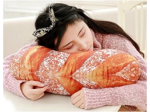Close-up of soft plush baguette cushion showing realistic texture used as a nap pillow