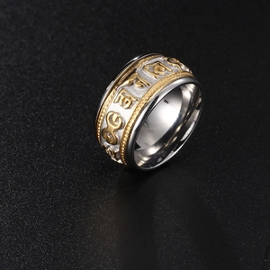 Rotating stainless steel mantra ring with gold trim and embossed religious characters