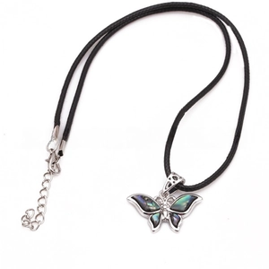 Macro shot of butterfly pendant with colorful abalone shell inlay on black cord