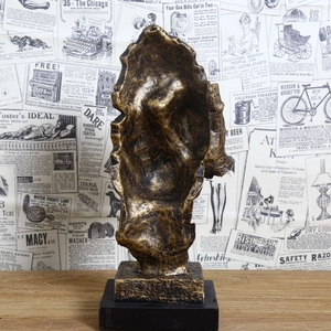 Macro detail of abstract golden sculpture featuring vintage textures and a black base