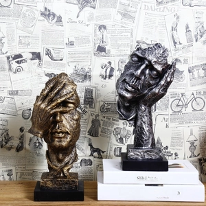 Artistic gold and silver resin sculptures on book display for creative home decor