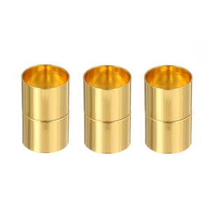 Close-up of three polished gold cylindrical magnetic clasps for DIY jewelry making