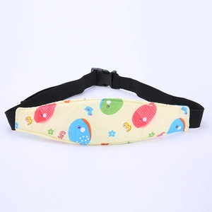 Detail of yellow baby head support strap with cartoon fish print and adjustable buckle