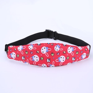 Detail view of red strap with rabbit and mushroom prints for toddler car seat head support