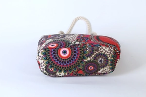 Close-up of bohemian canvas tote with colorful mandala prints and white rope handles