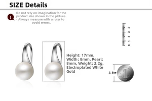 Detail view of 8mm pearl earrings with silver clasp next to a coin for size reference