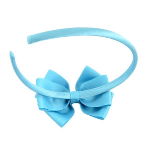 Light blue children's headband with large satin ribbon bow on a clean white background