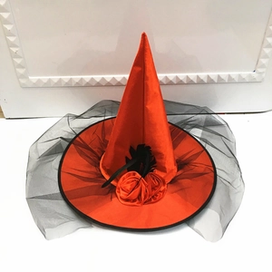 Detail of orange wizard hat with black feathers, orange roses and long mesh veil decor