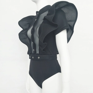 Detail of black mesh bodysuit with ruffled shoulders and belted waist on mannequin