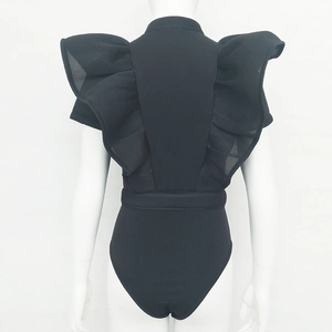 Detailed back view of black bodysuit featuring sheer mesh ruffles and a waist belt detail