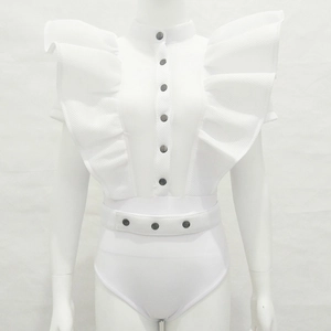 Detailed close-up of white ruffled sleeveless bodysuit with metal snap buttons on dress form