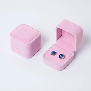 Pink velvet jewelry box with blue clover stud earrings shown in open and closed views