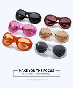 Flat lay of Y2K futuristic oversized sunglasses in six vibrant fashion-forward colors