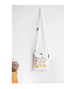 Detail of off-white canvas crossbody bag featuring autumn fox illustration and Lucky text