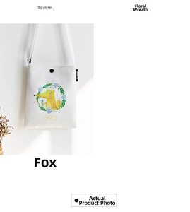 Close-up of white canvas crossbody bag featuring a floral fox print and adjustable strap