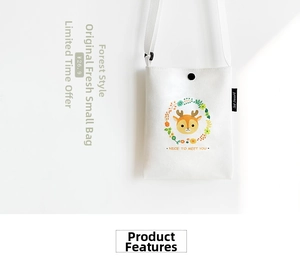 Detail of white canvas crossbody bag with deer illustration and snap button closure