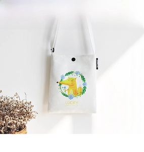 Detail of off-white canvas crossbody bag with fox wreath pattern and snap closure