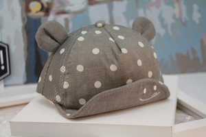 Detail of dark grey baby baseball cap with white polka dots and cute 3D ears