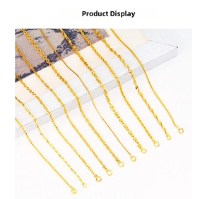 Detailed display of multiple gold-plated necklace chain styles including snake and cross link