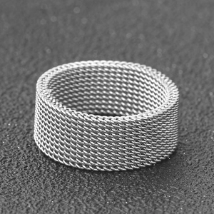 Macro close-up of 8mm silver mesh woven stainless steel band with polished metallic texture