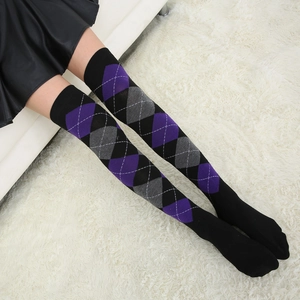 Detail of argyle pattern over-the-knee socks in purple, grey, and black knit fabric