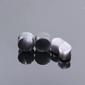 Detailed view of gray cat eye stone ear plugs with smooth saddle design in four sizes