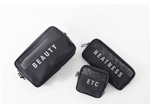 Three-piece black mesh cosmetic bag set featuring 'BEAUTY' and 'NEATNESS' lettering