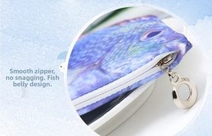 Detail of a realistic fish pencil case showing smooth white zipper and metal puller