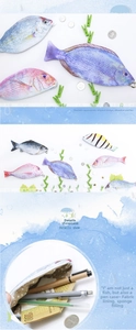 Detailed view of fish-shaped pencil cases with fabric lining and zipper closure