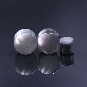 Macro detail of silver cat eye stone ear plugs showing unique silk luster and reflections
