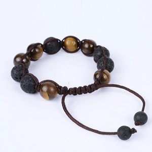 Adjustable 12mm tiger eye and black volcanic lava stone woven bracelet on white background