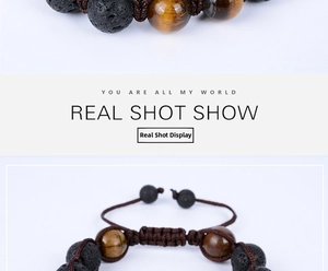 Detail of adjustable braided bracelet featuring 12mm tiger eye and volcanic lava stone beads
