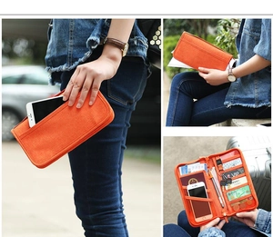 Detail view of orange travel passport wallet with multiple card slots and phone pocket