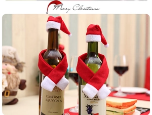 Close-up of mini red and white knitted Christmas hats and scarves on wine bottles