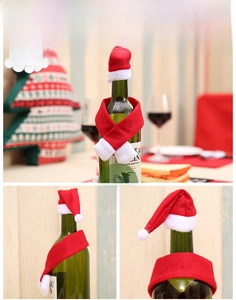 Detail view of mini red Christmas hat and scarf set for wine bottle decoration