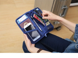 Blue canvas travel document organizer with multiple slots for passport and phone