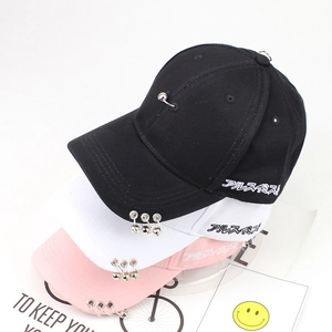 Close-up of baseball caps with metal rings and Japanese embroidery in black, white and pink