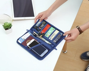 Macro view of blue travel organizer showing slots for passport, cards and key holder