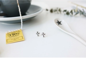Macro shot of vintage S925 sterling silver cross studs on a lifestyle background