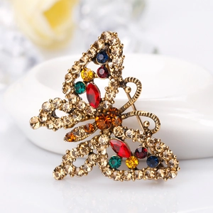 Vintage butterfly brooch with colorful rhinestones on a bronze metal base