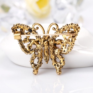 Retro bronze butterfly brooch with detailed hollow design and secure back pin closure