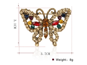Close-up of vintage butterfly brooch with colorful rhinestones measuring 3.1cm by 3.7cm