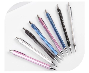 Macro view of metallic mechanical pencils with textured barrel and polished silver clip